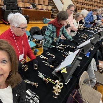 A table of bell ringers studying their music.
