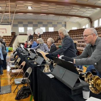 A table of bell ringers playing