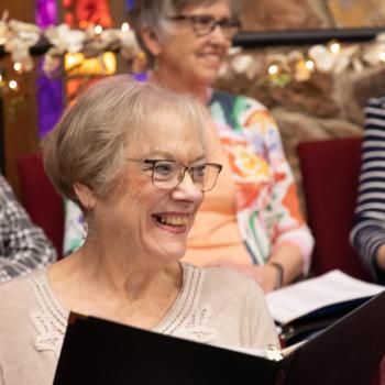 A soprano studiously listening to the conductor